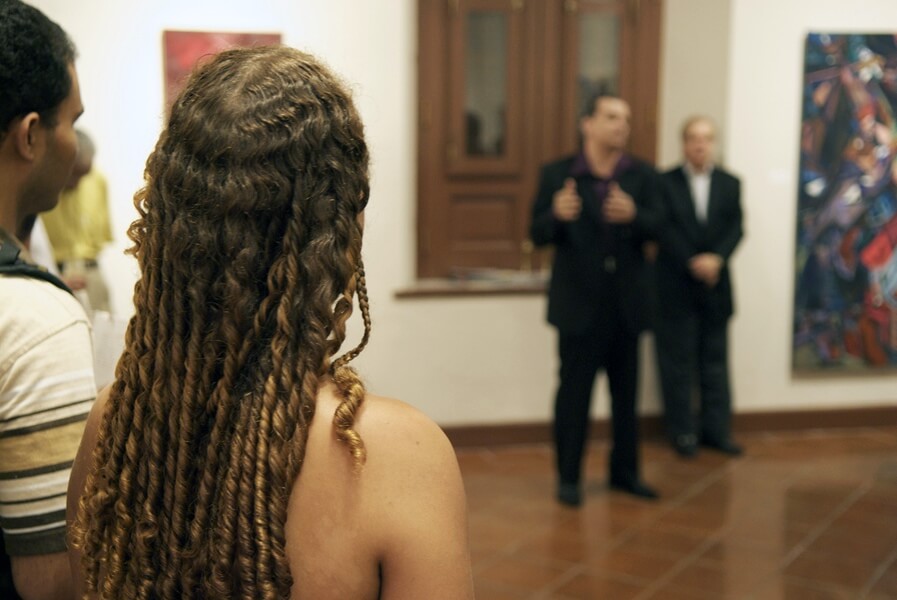Photo of Michael J. Korber the artist addressing guests at Ballajá Barracks at Museo de las Américas in Old San Juan, Puerto Rico at his Art Retrospective Exhibit, titled - A decade of line and color, in 2007.