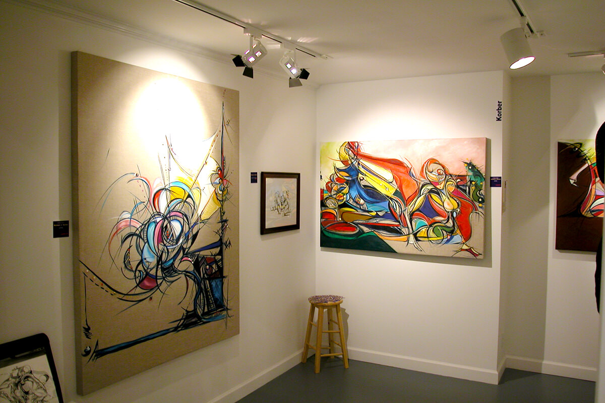 Photo of paintings by artist Michael J. Korber at Palm Beach Studios Annual Event in West Palm Beach, Florida.