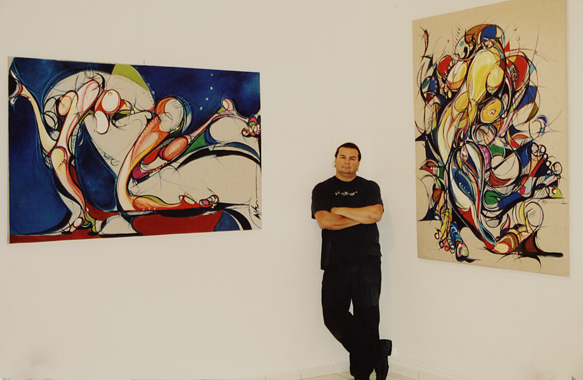 Photo of Michael J. Korber in Paris in front of his oil paintings at the Centre Culturel Christiane Peugeot  in France